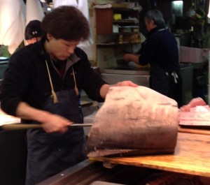 Worker filleting swordfish